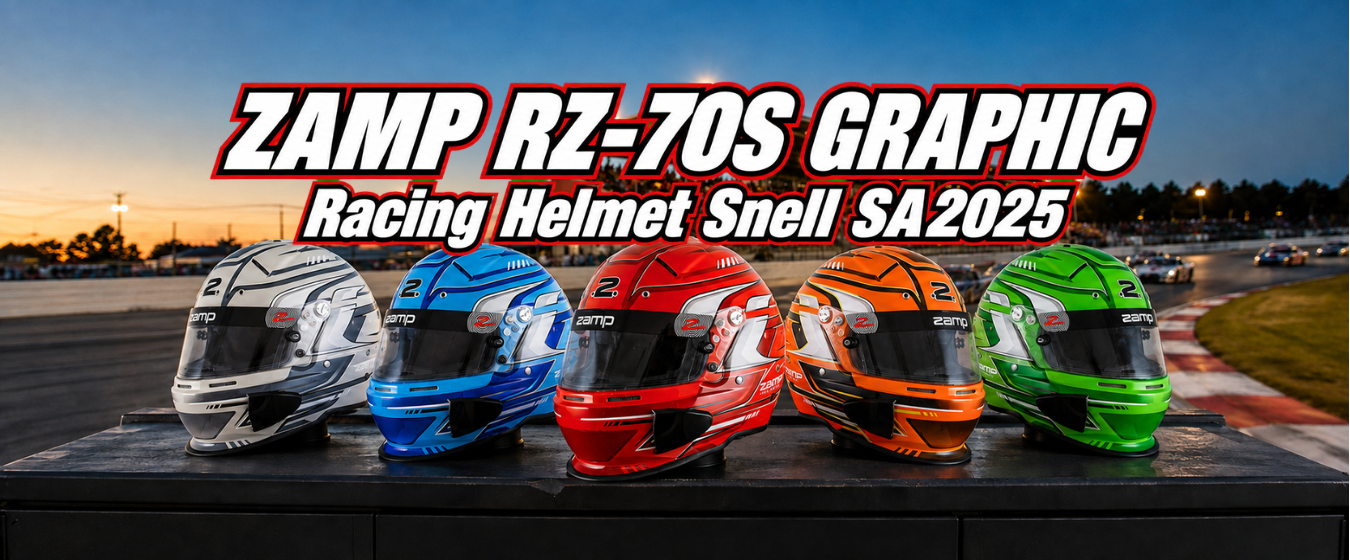 Five Zamp RZ-70S Graphic racing helmets in silver, blue, red, orange, and green, lined up on a pit-side table at a racetrack at dusk, with a grandstand and cars on track in the background.