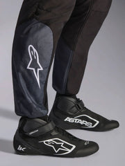 Close Up Leg view of a driver wearing the Alpinestars KMX-5 V3 Kart Suit in Black color at FAST RACER