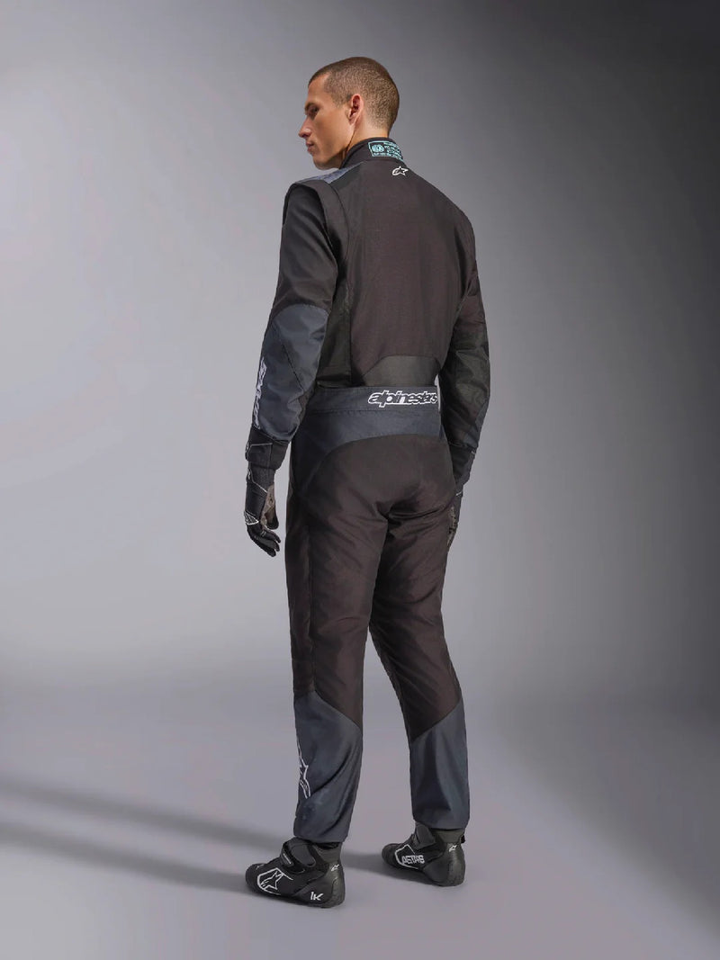 Side Back view of a driver wearing the Alpinestars KMX-5 V3 Kart Suit in Black Color at FAST RACER