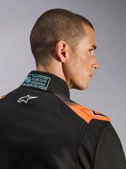 Close Up Back view of a driver wearing the Alpinestars KMX-5 V3 Kart Suit in Orange/Black color at FAST RACER