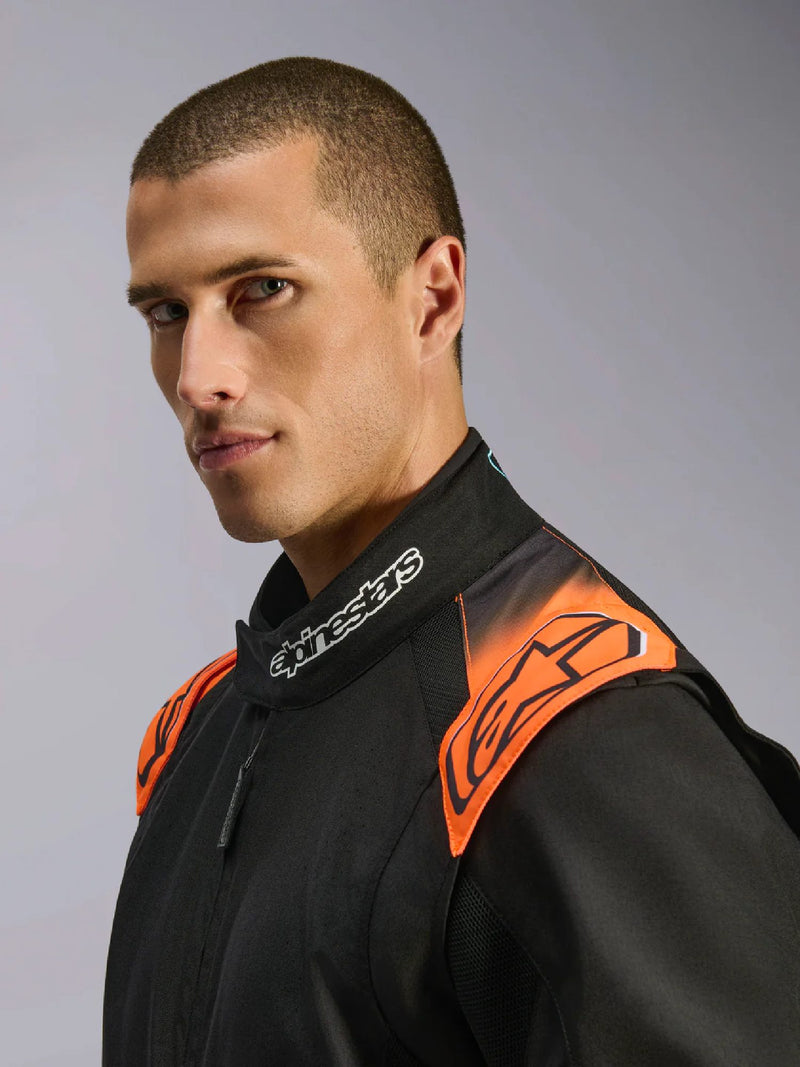 Close Up Front view of a driver wearing the Alpinestars KMX-5 V3 Kart Suit in Orange/Black color at FAST RACER