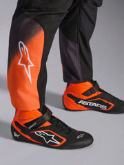 Close Up Leg view of a driver wearing the Alpinestars KMX-5 V3 Kart Suit in Orange/Black Color at FAST RACER