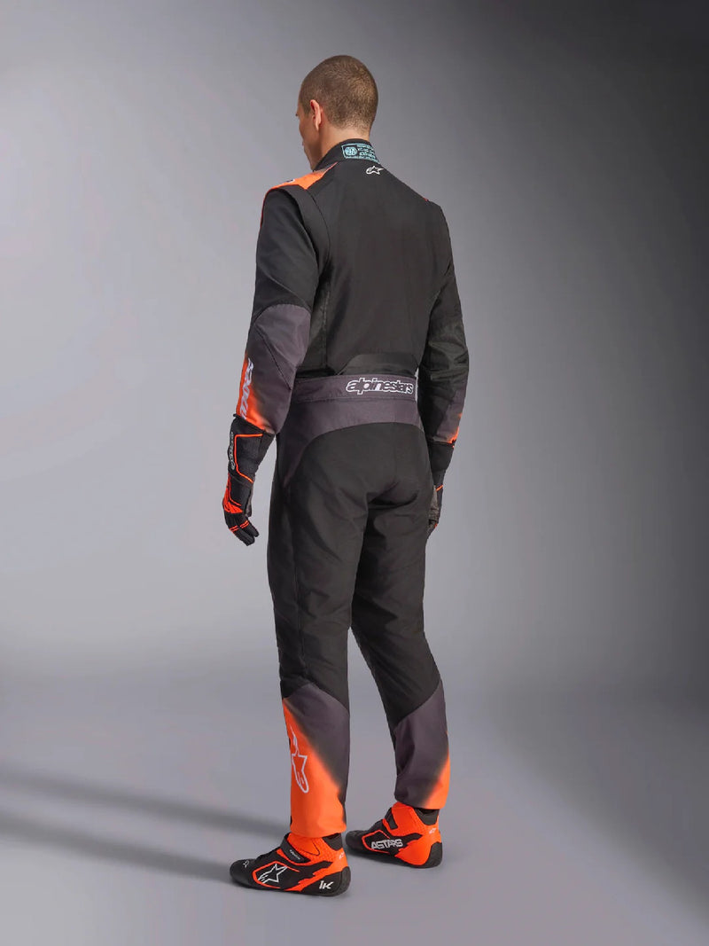 Side Back view of a driver wearing the Alpinestars KMX-5 V3 Kart Suit in Orange/Black color at FAST RACER