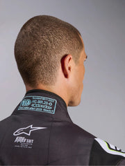 Close up back view of a driver wearing the Alpinestars KMX-9 V3 Graphic 3 Kart Suit in Black/Yellow color at FAST RACER