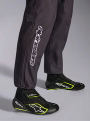 Close Up Leg view of a driver wearing the Alpinestars KMX-9 V3 Graphic 3 Kart Suit in Black/Yellow color at FAST RACER