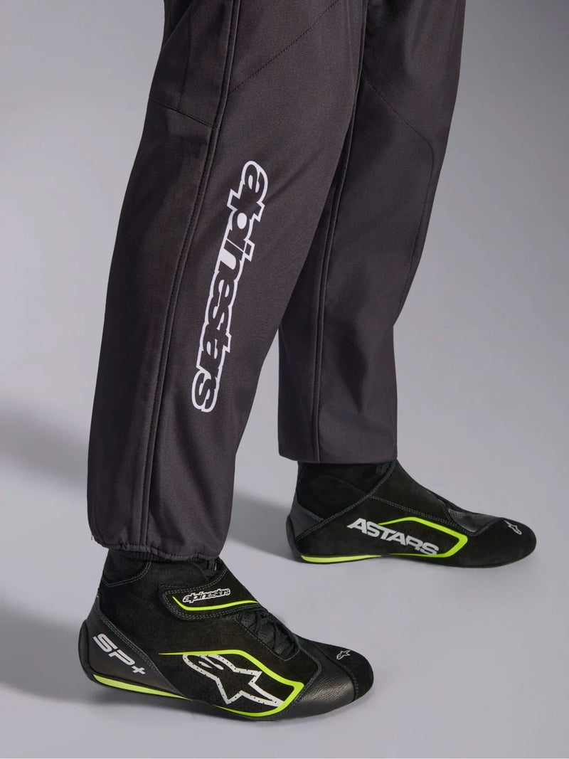 Close Up Leg view of a driver wearing the Alpinestars KMX-9 V3 Graphic 3 Kart Suit in Black/Yellow color at FAST RACER