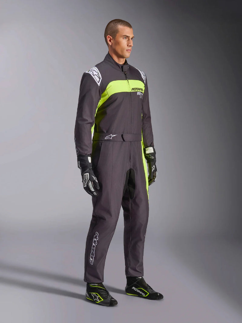 Side right view of a driver wearing the Alpinestars KMX-9 V3 Graphic 3 Kart Suit in Black/Yellow color at FAST RACER