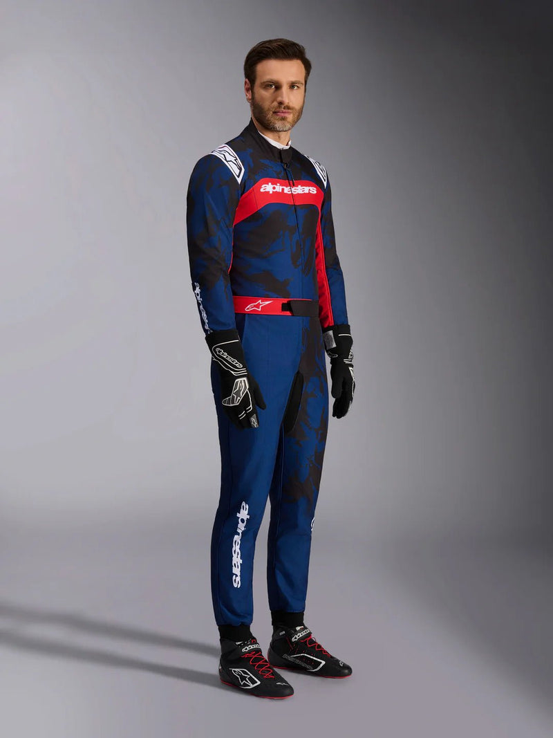Side Right view of a driver wearing the Alpinestars KMX-9 V3 Graphic 5 Kart Suit in Navy Blue/Red color at FAST RACER