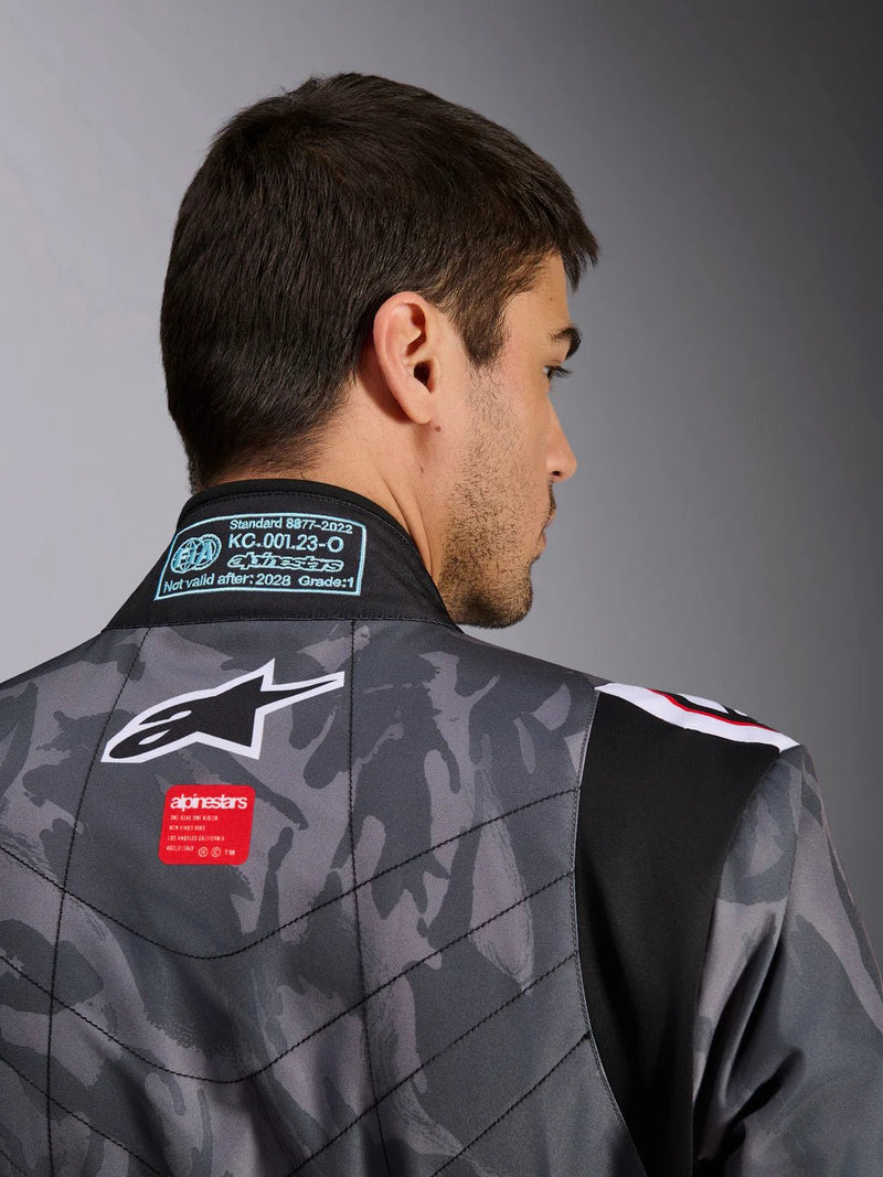 Close Up Back view of a driver wearing the Alpinestars KMX-9 V3 Graphic 5 Kart Suit in Dark Gray/Black color at FAST RACER