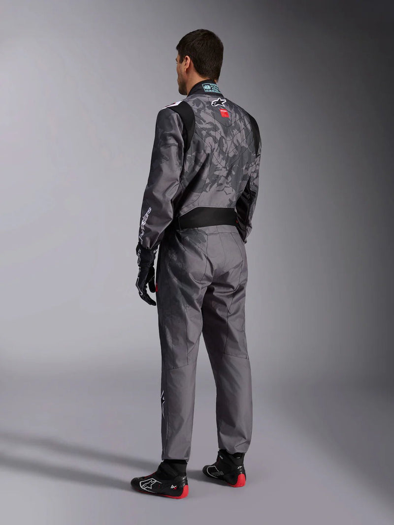 Side Back view of a driver wearing the Alpinestars KMX-9 V3 Graphic 5 Kart Suit in Dark Gray/Black color at FAST RACER
