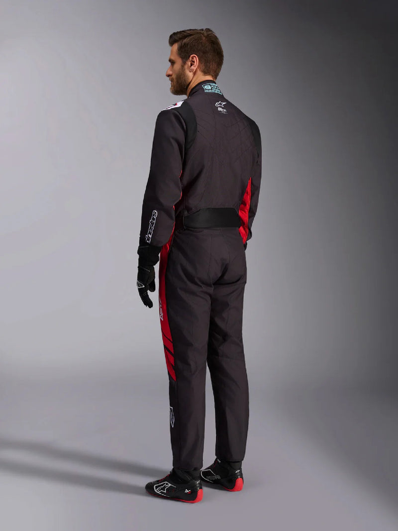 Side back view of a driver wearing the Alpinestars KMX-9 V3 Graphic 3 Kart Suit in Black/Red color at FAST RACER