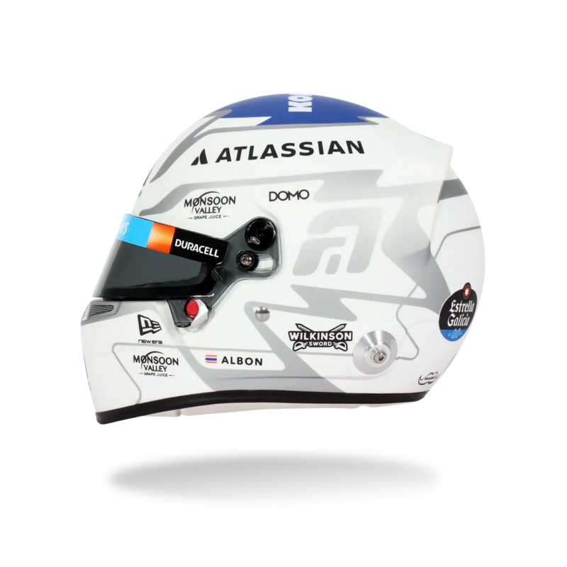 Side view of Alex Albon’s 2026 F1 Bell mini helmet with Atlassian, Duracell, Albon, Wilkinson Sword, and Estrella Galicia graphics - Fast Racer