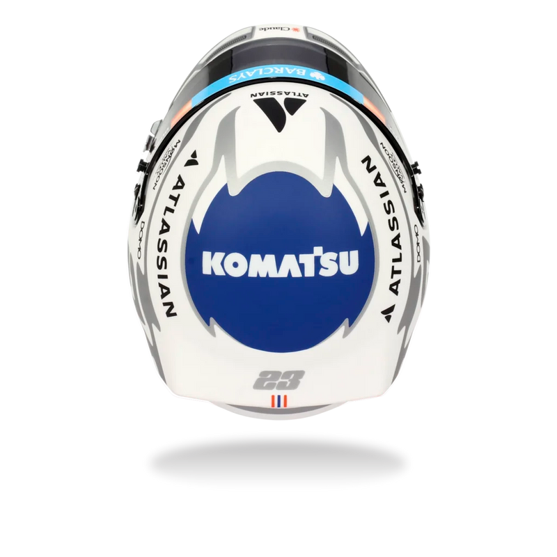 Top view of Alex Albon’s 2026 F1 Bell mini helmet with Komatsu, Atlassian, and blue-and-white graphics - Fast Racer