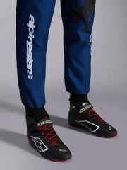 Close Up leg view of a driver wearing the Alpinestars KMX-9 V3 Graphic 5 Kart Suit in Navy Blue/Red color at FAST RACER