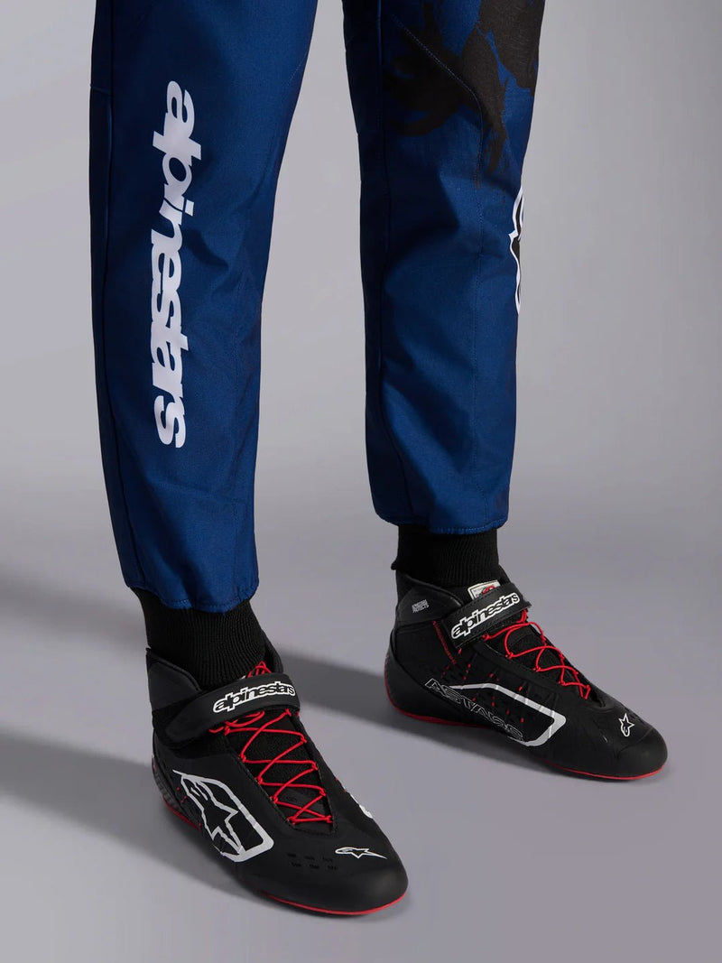 Close Up leg view of a driver wearing the Alpinestars KMX-9 V3 Graphic 5 Kart Suit in Navy Blue/Red color at FAST RACER