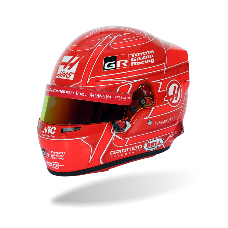 Front three-quarter view of Esteban Ocon’s red 2026 F1 Bell 1:2 scale mini helmet with Toyota Gazoo Racing and Haas graphics - Fast Racer