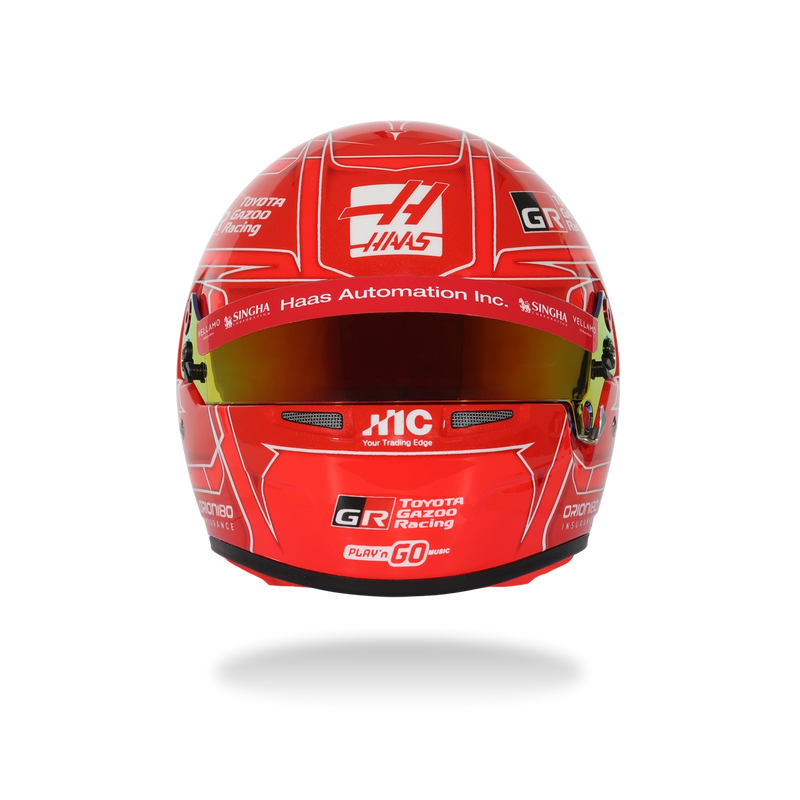 Side view of Esteban Ocon’s red 2026 F1 Bell mini helmet with white linework, sponsor logos, and Bell branding - Fast Racer