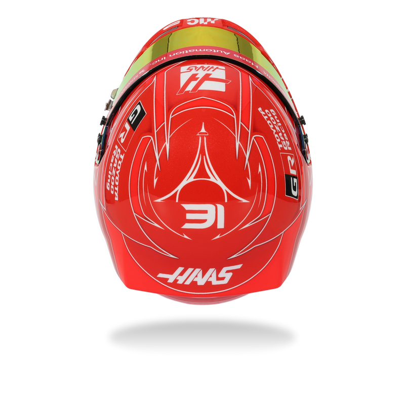 Opposite side view of Esteban Ocon’s red 2026 F1 Bell mini helmet with Toyota Gazoo Racing, Haas, Mansory, and Bell graphics - Fast Racer