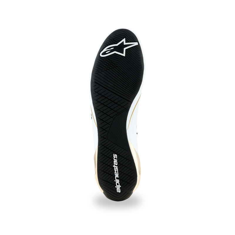 Alpinestars Supertech K karting shoe in White/Black/Gold, black rubber outsole with asymmetric tread and white logos