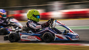 Junior Kart Driver in Action with a Bell KC7-CMR Karting Helmet Lando Norris and go-kart with FAST RACER logo and colors.