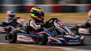 Junior Kart Driver in Action with a Bell KC7-CMR Karting Helmet Oscar Piastri and go-kart with FAST RACER logo and colors.