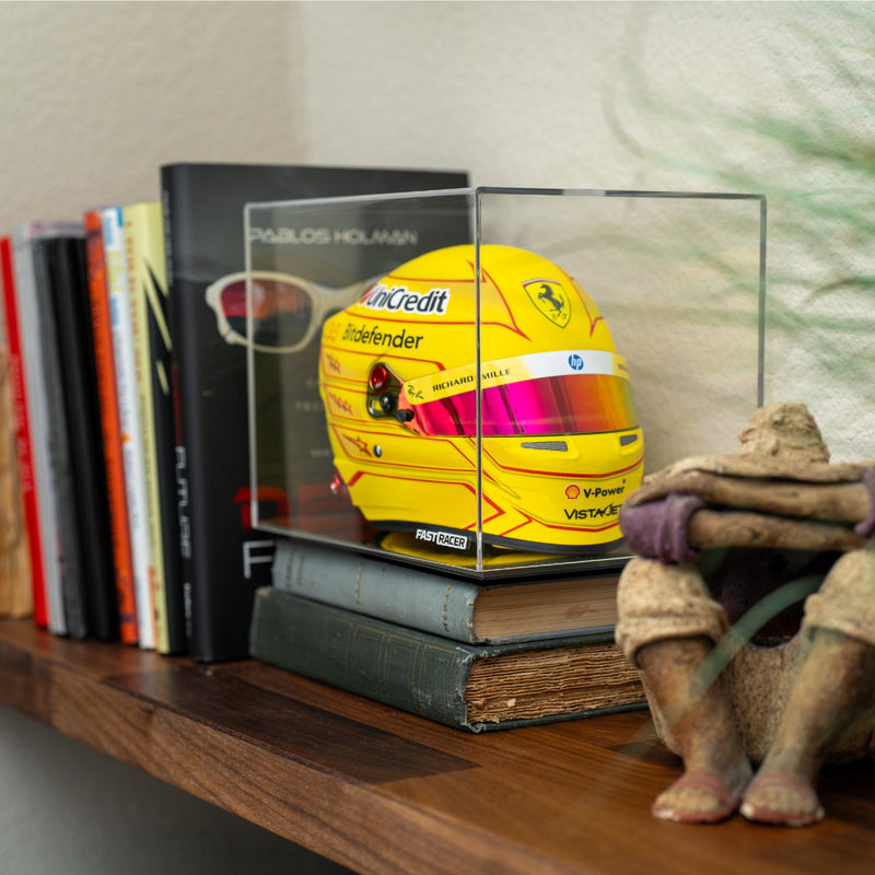 FAST RACER Premium 1:2 Scale Mini Helmet Display Case with Lewis Hamilton 2026 Mini Helmet Inside and Placed on a Bookshelf.